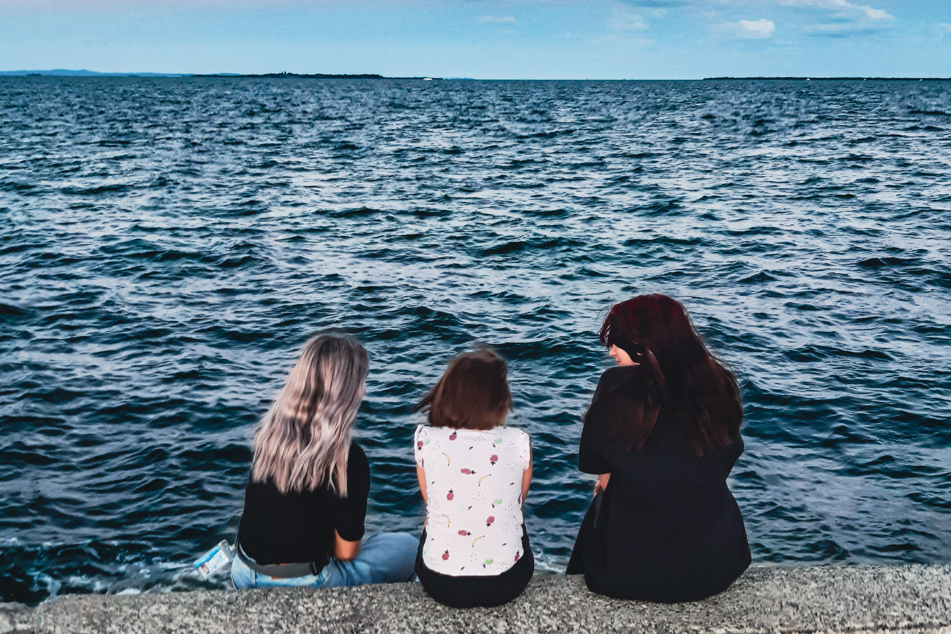 Young people spending time together by the water