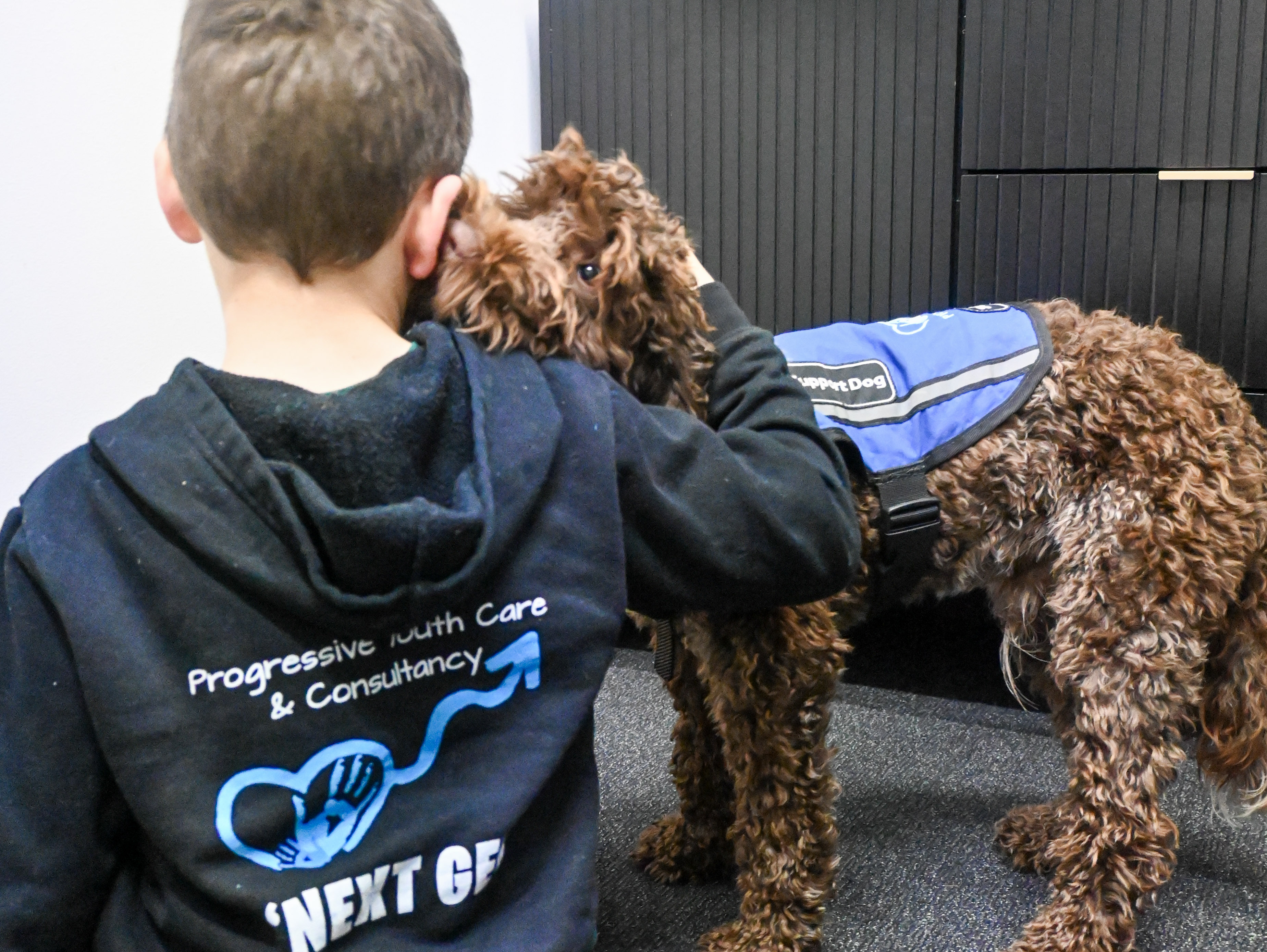 PAWS therapy dog with a young person