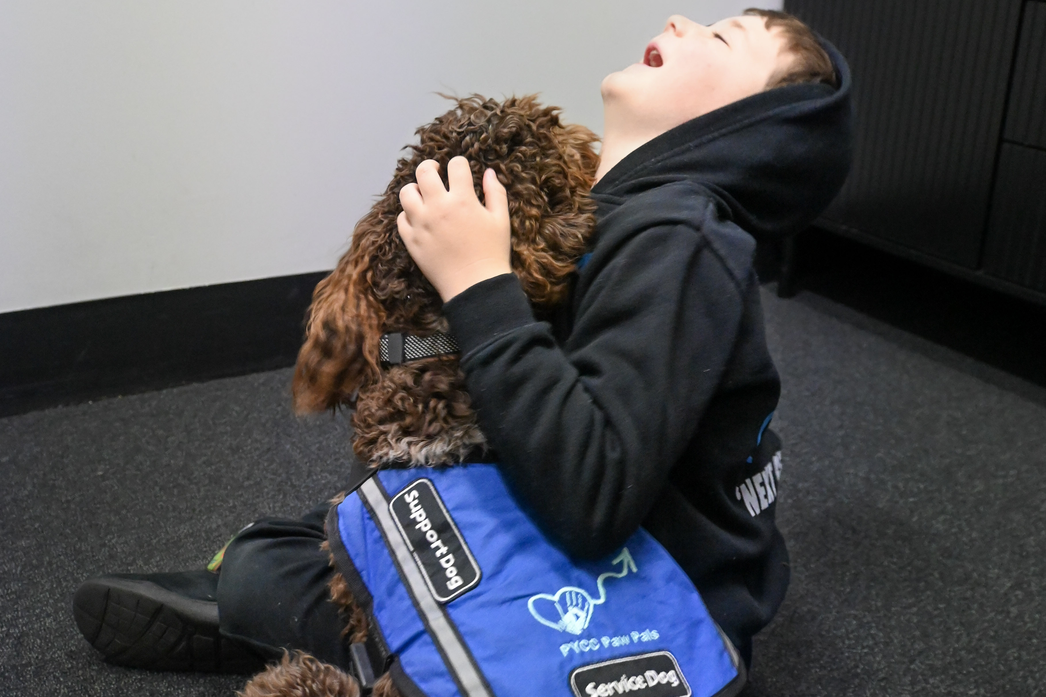 Young person connecting with a PAWS therapy dog